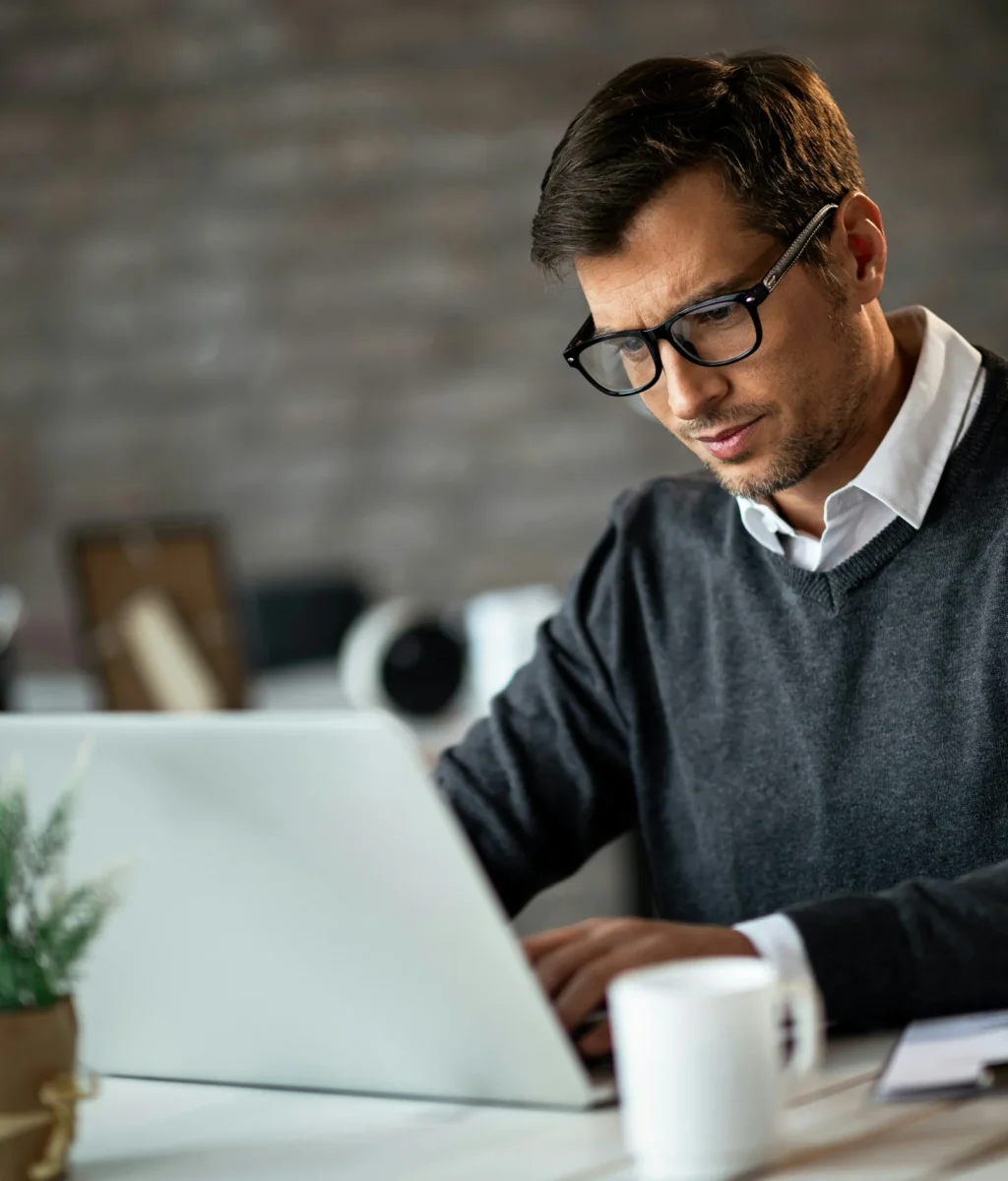 Man Working On Laptop At Office