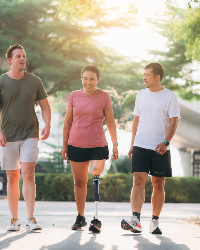 Amputee Woman Walking With Friends Outside